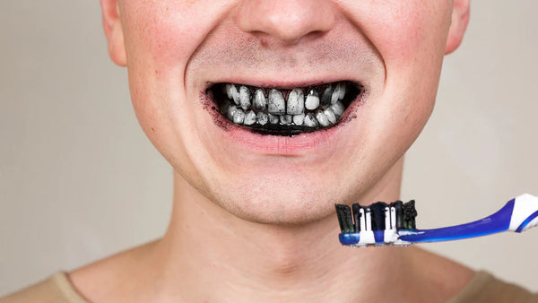 Man_Brushing_with_Charcoal_Toothpaste_1024x1024.webp